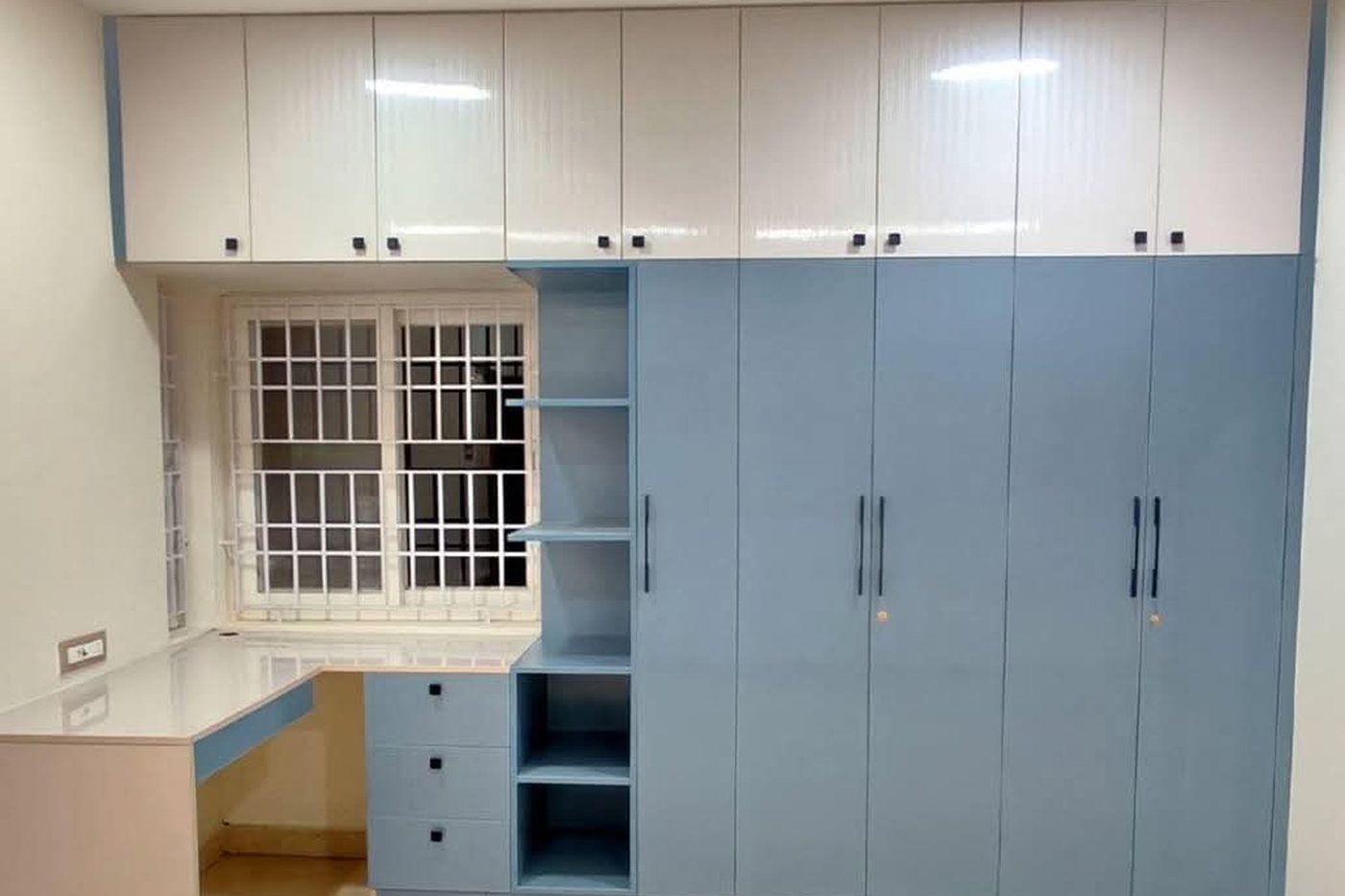 After — finished blue and white modular wardrobe with study counter