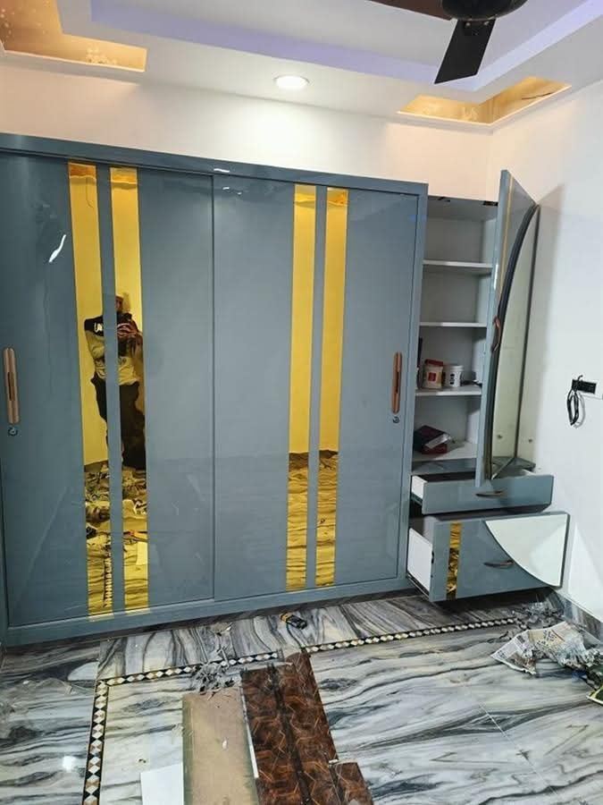 Blue wardrobe with gold stripe detailing and dresser mirror