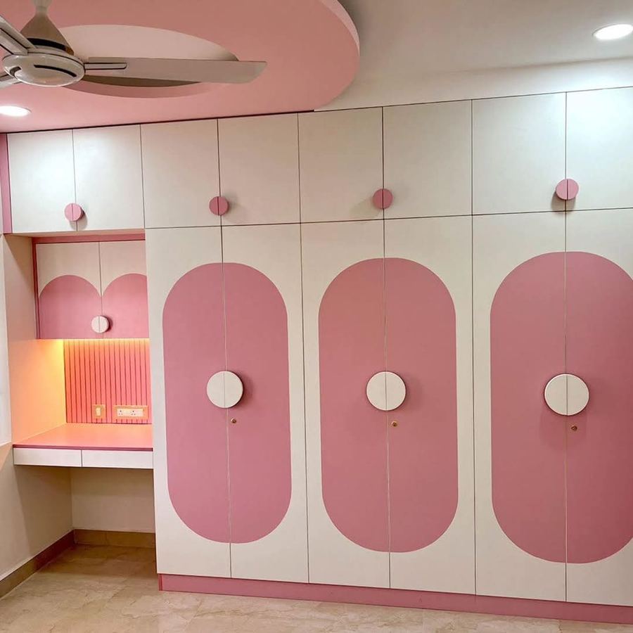 Kids bedroom with pastel pink wardrobe and built-in study nook