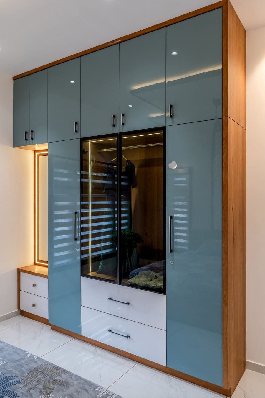 Sky blue wardrobe with wooden trim, drawers and mirror panel