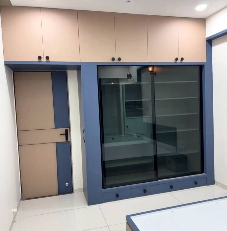 Sliding glass door wardrobe with blue accent panels