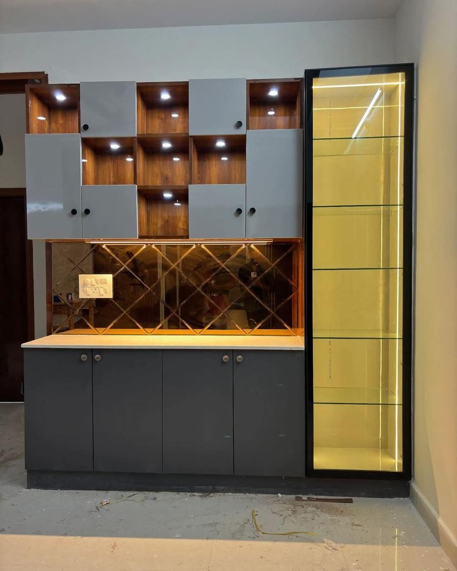 Dark grey kitchen units with backlit tall glass display cabinet