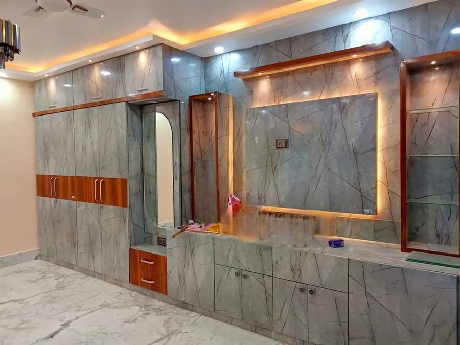 Backlit marble TV unit with recessed lighting in a Hyderabad living room