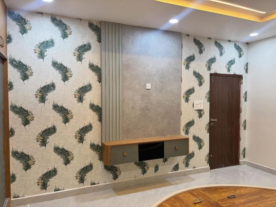 Living room TV unit with leaf-pattern designer wallpaper feature wall