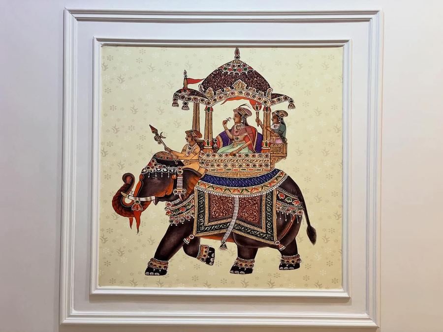 Framed traditional Indian art panel in a moulded wall recess